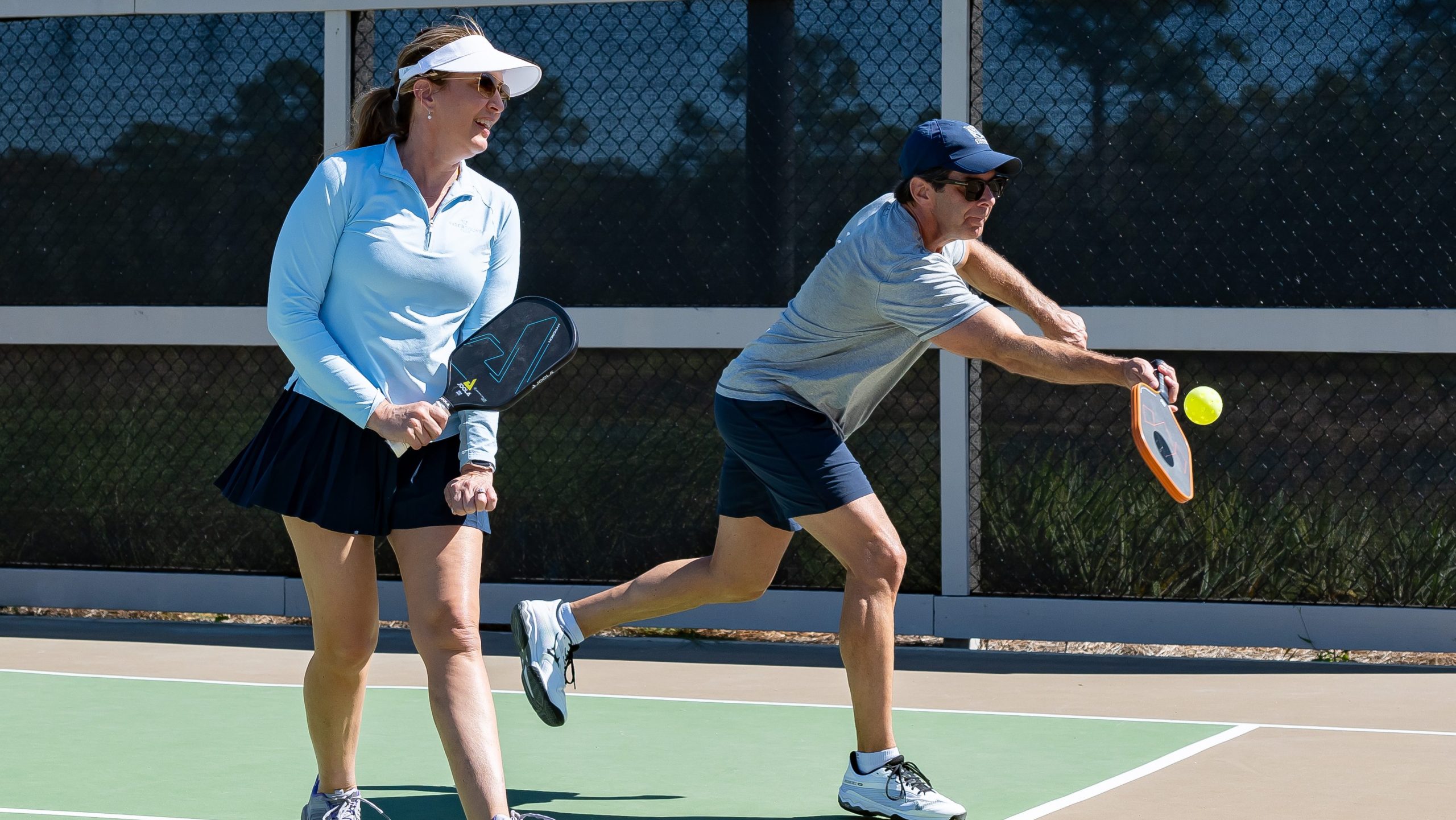 Couple playing pickle ball on the private courts at Camp Creek Inn. 