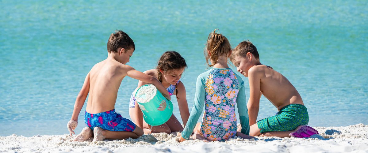 Kids building sandcastles on the Gulf of Mexico