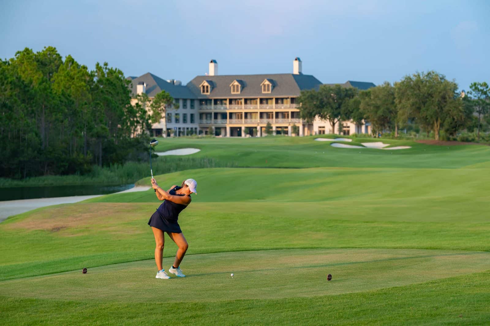 A woman playing golf at Camp Creek Inn.