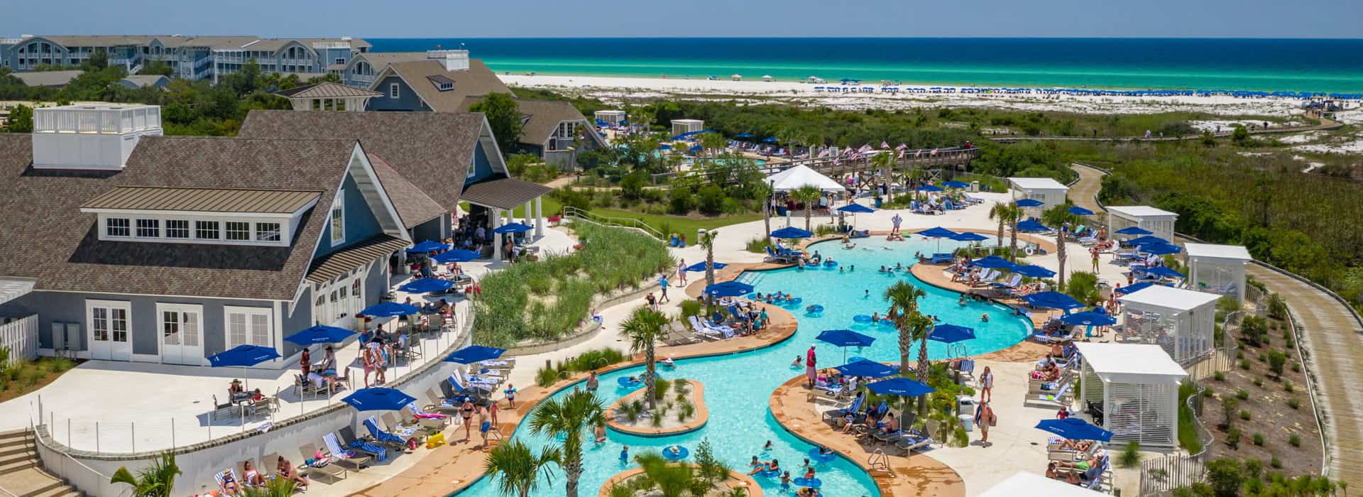 Aerial view of the Watersound Beach Club off of 30A with a view of the Gulf visible just beyond the lazy river pool and the boardwalk.