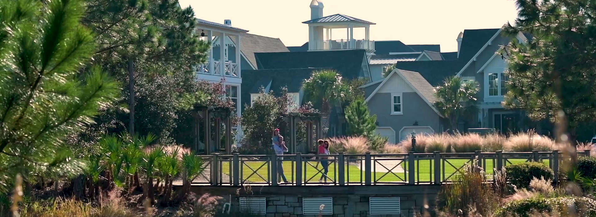 View of a family on the boardwalk at Watersound Inn in Inlet Beach, Florida.