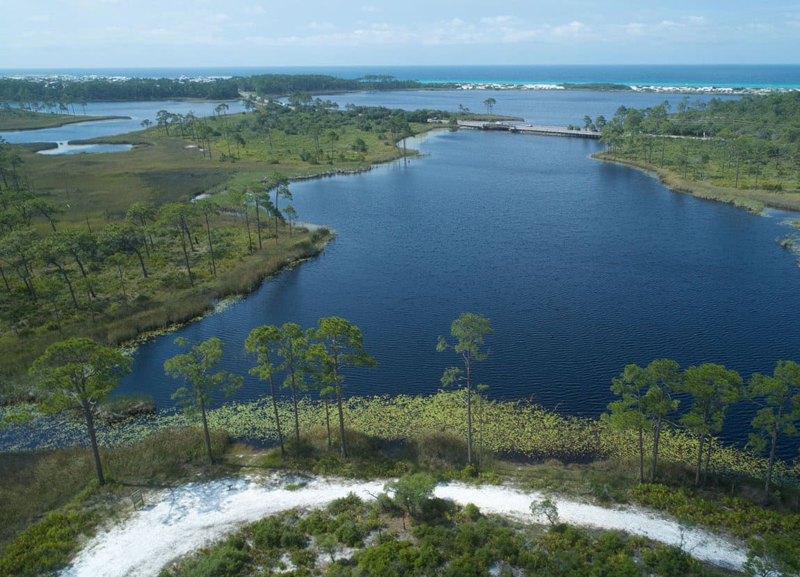An aerial view of the back and Gulf along Highway 30A.