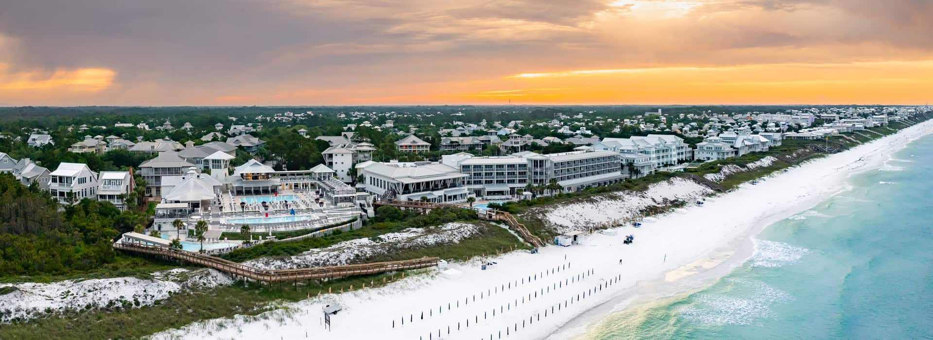 Aerial view of Watercolor Inn at sunset on the beach.