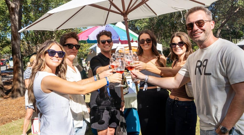 A group toast during a sunny day at the Harvest Wine & Food Festival on 30A