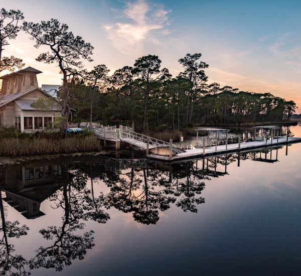 Sunset view of WaterColor BoatHouse on Western Lake, a rare coastal dune lake along Florida's Scenic Highway 30A