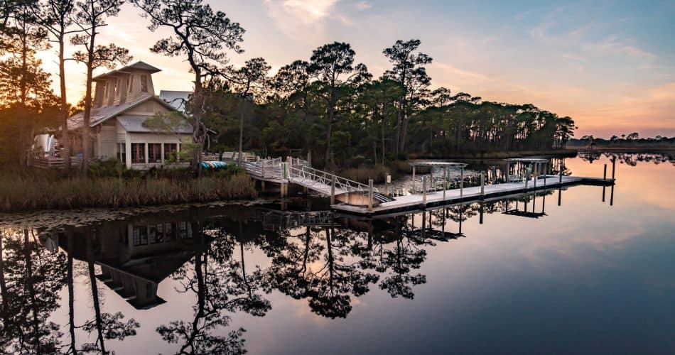 Sunset view of WaterColor BoatHouse on Western Lake, a rare coastal dune lake along Florida's Scenic Highway 30A