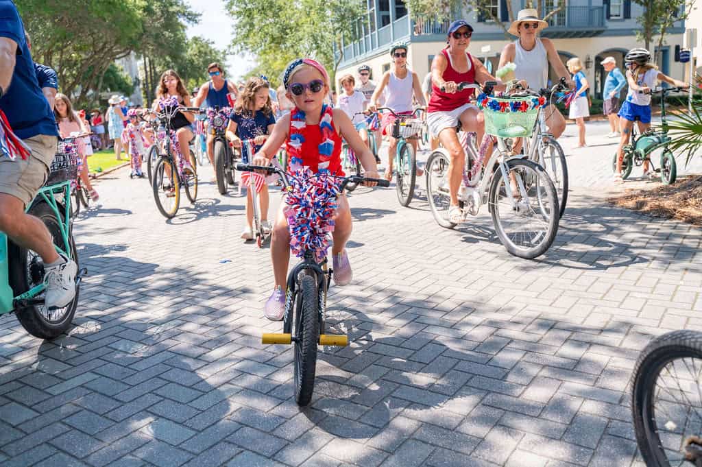 Children riding bikes during summer events on 30A in 2026.